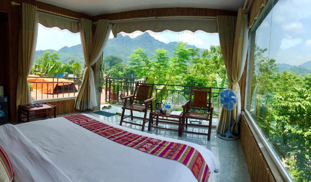 Mai Chau from Hanoi 2026 | Travel Guide, Transfer & Things To Do Mid-range Mai Chau boutique lodge private bungalow with outdoor terrace overlooking green rice fields and mountains