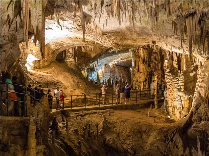 Mai Chau from Hanoi 2026 | Travel Guide, Transfer & Things To Do Chieu Cave Hang Chieu in Mai Chau with dramatic light beams shining through limestone cave entrance over stalactites