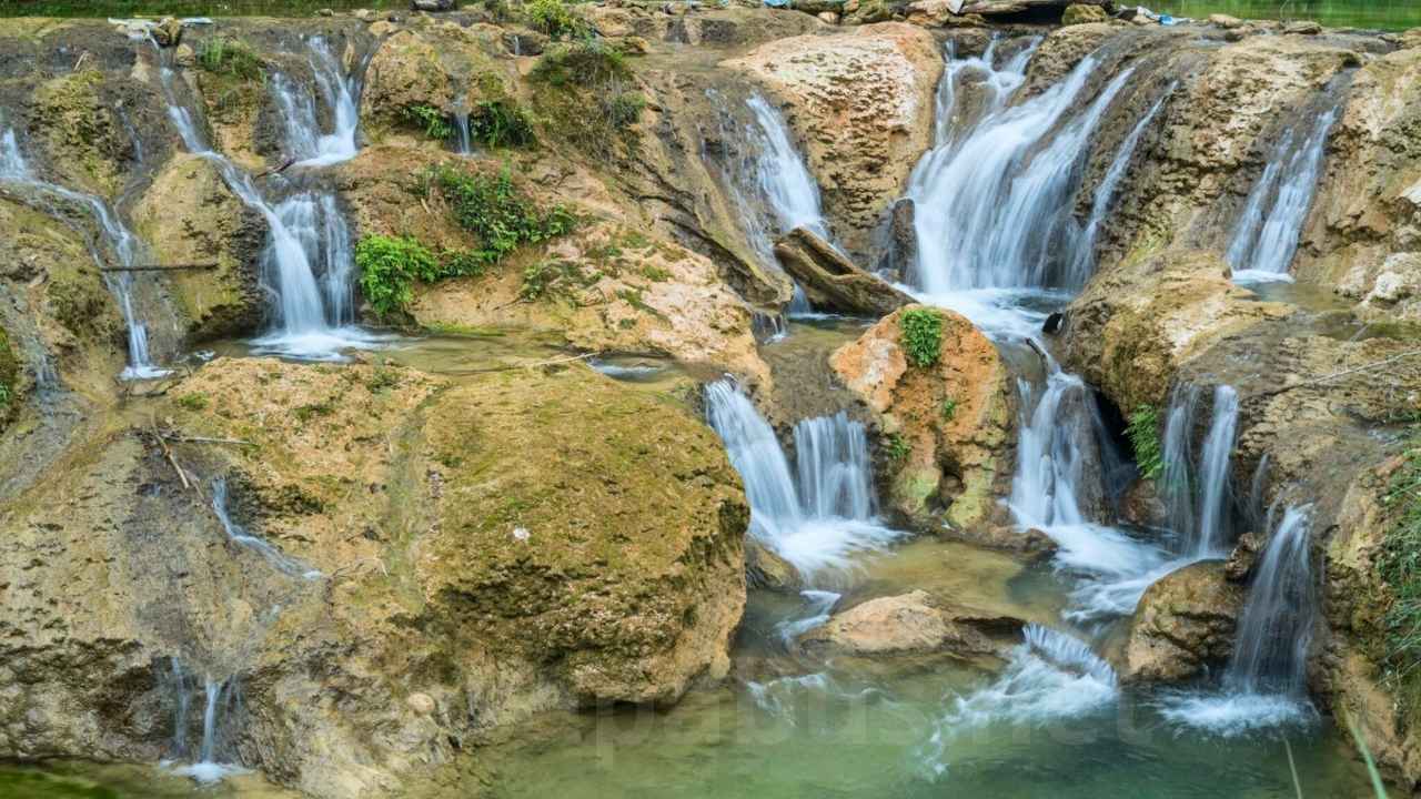 Pu Luong Travel Guide 2026: 8 Highlights, Best Time & Tours from Hanoi Hieu Waterfall surrounded by jungle in Pu Luong