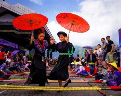 Mai Chau from Hanoi 2026 | Travel Guide, Transfer & Things To Do Traditional White Thai cultural dance performance at Mai Chau homestay with women in colorful traditional dress and bamboo pole dancing