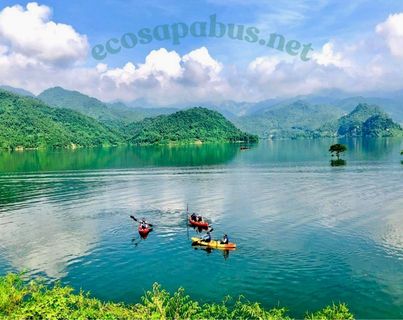 Mai Chau from Hanoi 2026 | Travel Guide, Transfer & Things To Do Kayaking on calm green water surrounded by rice fields and bamboo in Mai Chau valley Vietnam