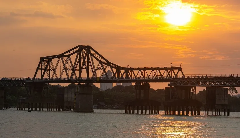 Hanoi best things to do & travel guide Long Bien Bridge at sunrise with cyclists