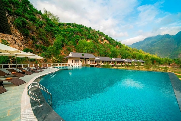 Mai Chau from Hanoi 2026 | Travel Guide, Transfer & Things To Do Luxury Mai Chau resort infinity pool overlooking terraced rice fields and limestone mountains at sunset Vietnam