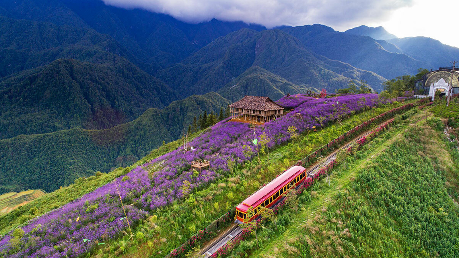 SaPa Best Things To Do Trekkers walking along a narrow trail through Muong Hoa Valley rice terraces