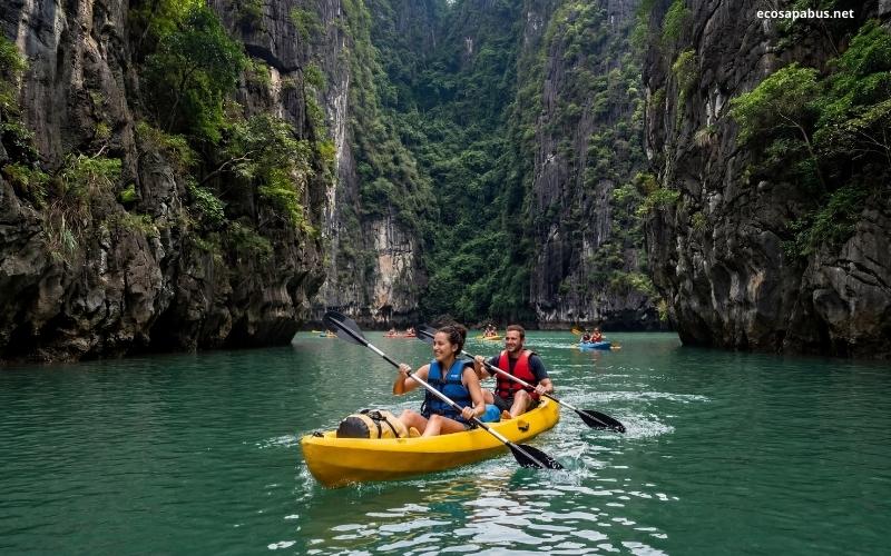 Ha Long Bay kayaking through limestone lagoon — best activity on Ha Long Bay cruise tour