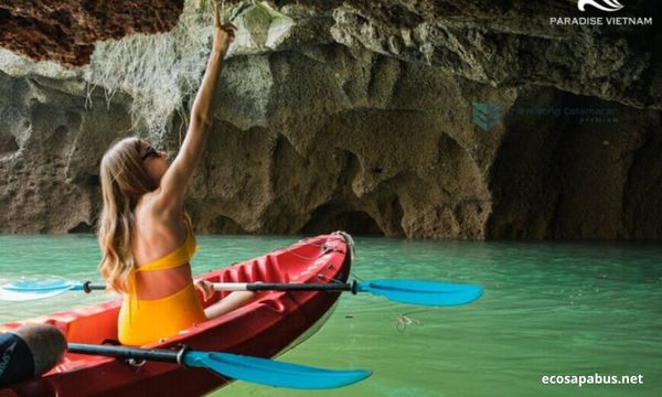 Kayaking through sea arch in Lan Ha Bay