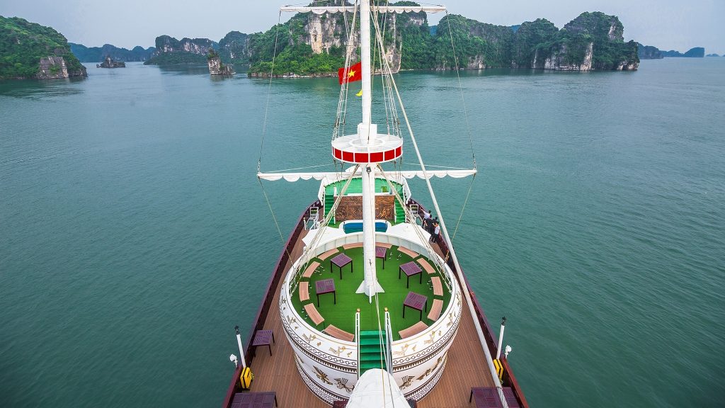 Dragon Legend Cruise sundeck and outdoor seating overlooking Bai Tu Long Bay