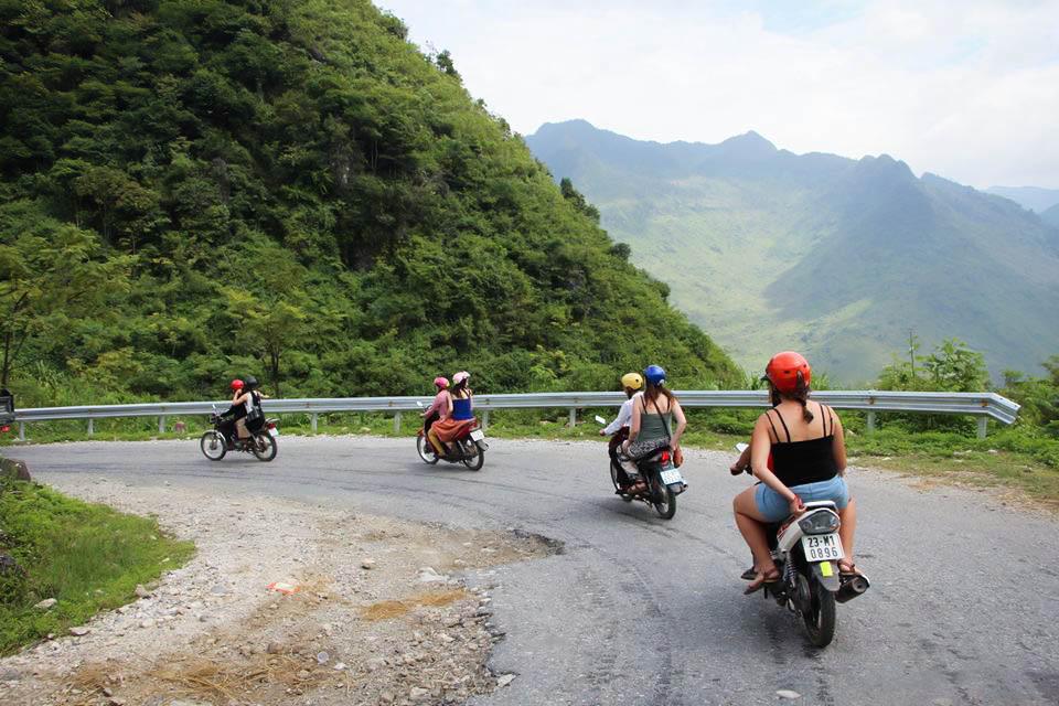 Travelers riding motorbikes toward Dong Van on the Ha Giang Loop