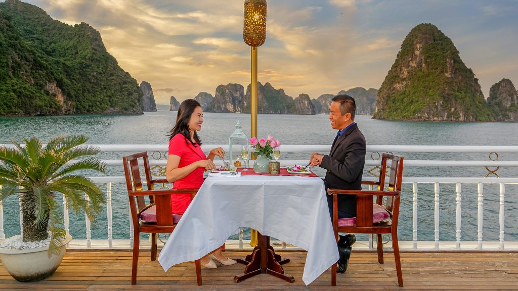 Heritage Line Violet Cruise sundeck and outdoor seating overlooking Bai Tu Long Bay