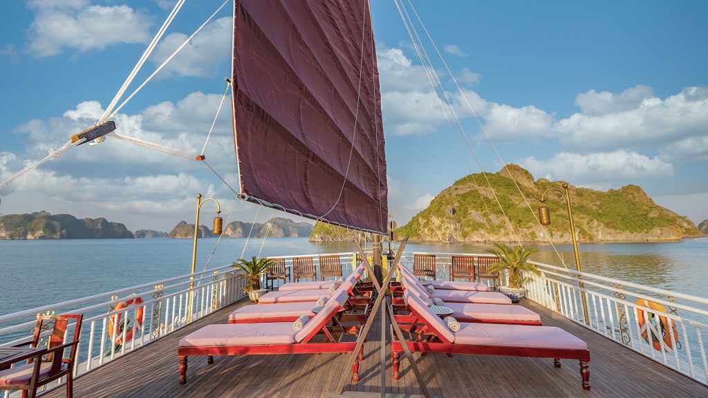 Heritage Line Violet Cruise sundeck and outdoor seating overlooking Bai Tu Long Bay
