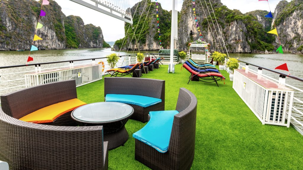 Queen Luxury Day Cruise sundeck and outdoor seating overlooking Halong Bay