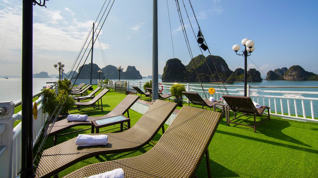 Signature Cruise sundeck and outdoor seating overlooking Bai Tu Long Bay